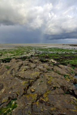 Donkere, dreigende wolkenlucht van regenbui boven de Waddenzee bij vogelreservaat De Volharding op Waddeneiland Texel.
