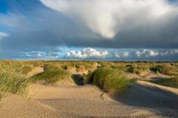 Grote wolk van regenbui boven wuivend helmgras in de zeeduinen van De Hors op het zuidpunt van Waddeneiland Texel
